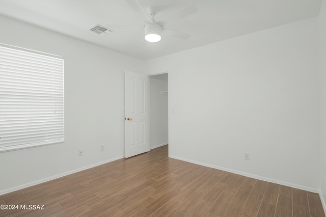 unfurnished room with ceiling fan and wood-type flooring