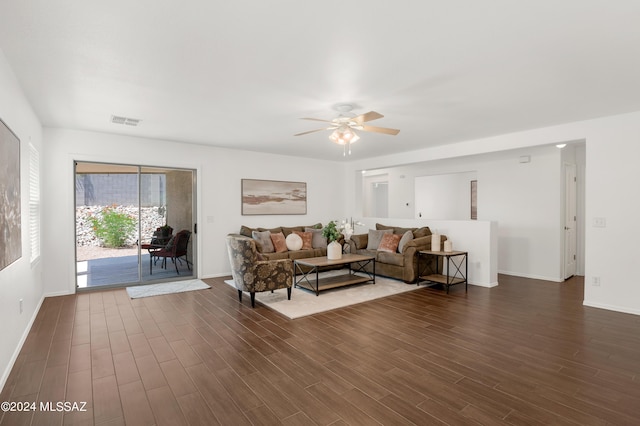 living room with dark hardwood / wood-style flooring and ceiling fan