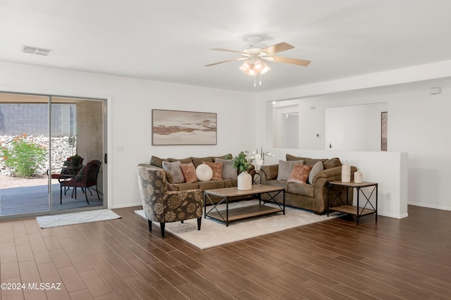 living room featuring ceiling fan and dark hardwood / wood-style flooring