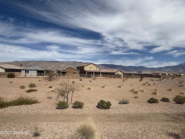 view of yard featuring a mountain view and fence