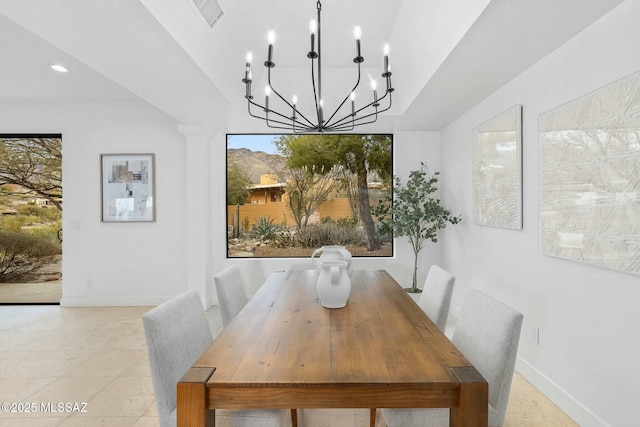 tiled dining room with an inviting chandelier