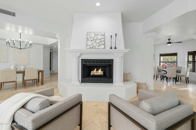 living room featuring tile patterned floors and ceiling fan with notable chandelier