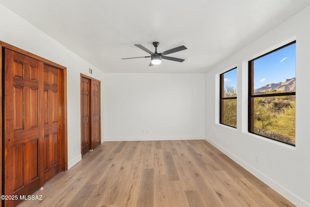 spare room featuring light hardwood / wood-style floors and ceiling fan