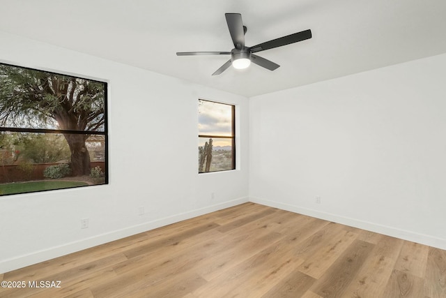 spare room featuring ceiling fan and light hardwood / wood-style floors