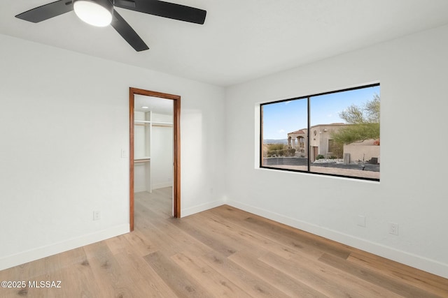 unfurnished room with ceiling fan and light wood-type flooring