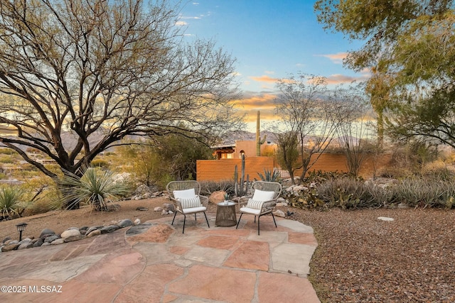 view of patio terrace at dusk