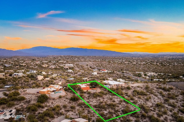 aerial view at dusk featuring a mountain view