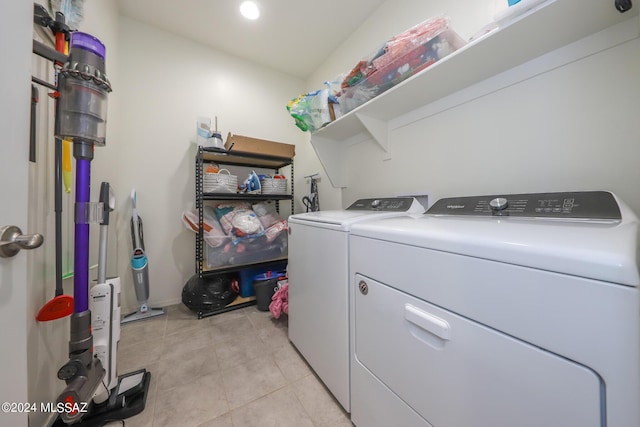 laundry area featuring washing machine and dryer and light tile patterned floors