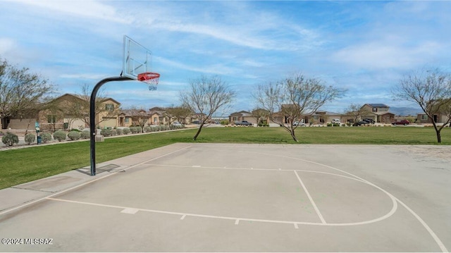 view of sport court featuring a lawn