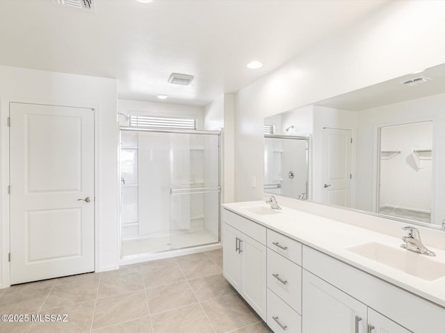 255 N Spring Flower Dr, Tucson, AZ 85748 - full bath with a stall shower, double vanity, tile patterned floors, a closet, and recessed lighting
