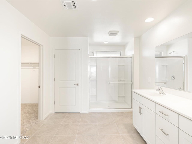 255 N Spring Flower Dr, Tucson, AZ 85748 - full bath with a shower stall, vanity, a spacious closet, and tile patterned flooring