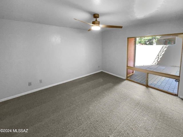 carpeted spare room featuring ceiling fan