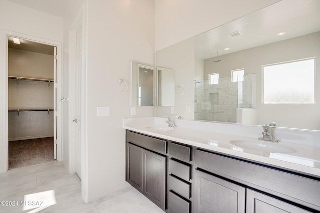 bathroom featuring vanity, tile patterned floors, and walk in shower