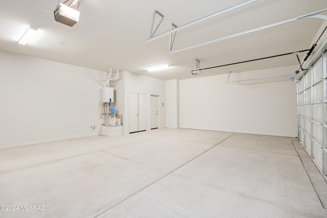 garage with a garage door opener and water heater