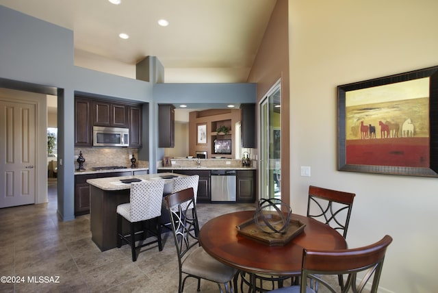 dining space with a towering ceiling