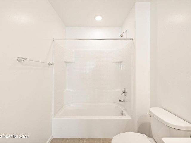 bathroom with shower / washtub combination and toilet