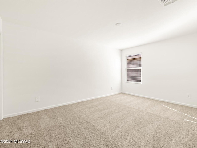 unfurnished room with light carpet