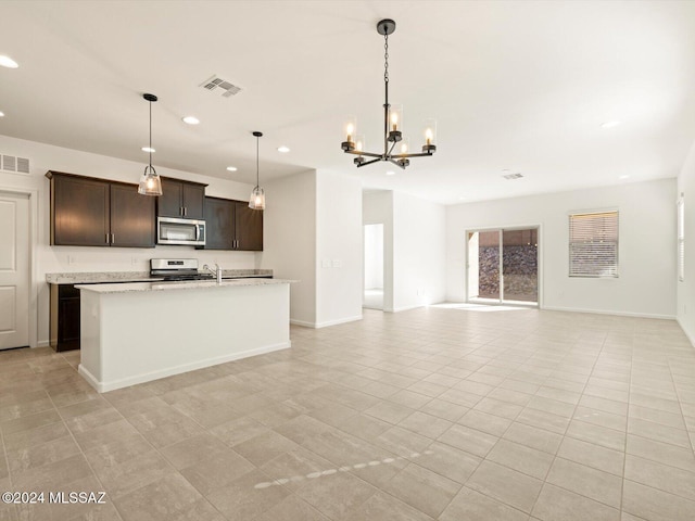 kitchen with light stone counters, a chandelier, hanging light fixtures, stainless steel appliances, and dark brown cabinets