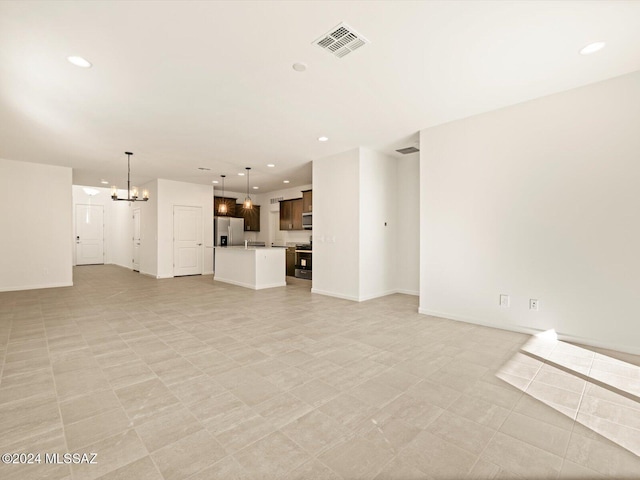 unfurnished living room with a notable chandelier