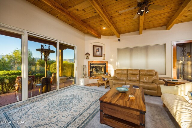 carpeted living room with ceiling fan, wooden ceiling, and beamed ceiling