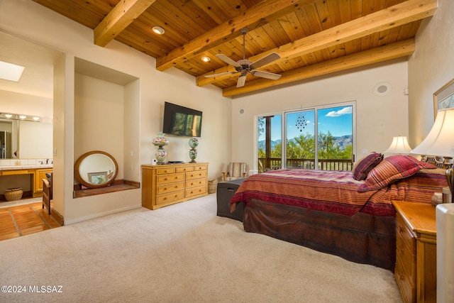 bedroom with connected bathroom, access to exterior, beam ceiling, and wooden ceiling