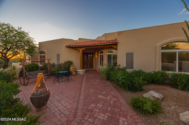 patio terrace at dusk with a fire pit