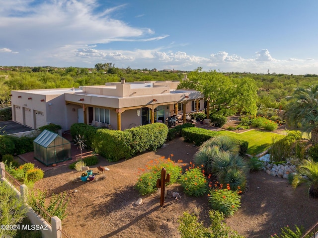 pueblo-style home featuring an outdoor structure