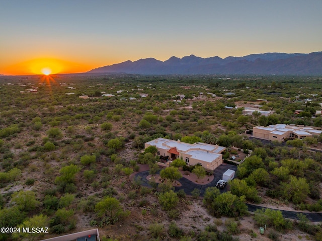 aerial view at dusk featuring a mountain view