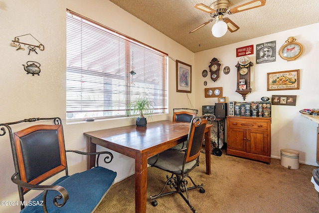 carpeted dining room featuring ceiling fan and a textured ceiling