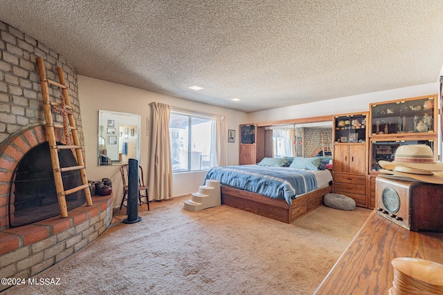 bedroom with carpet and a textured ceiling