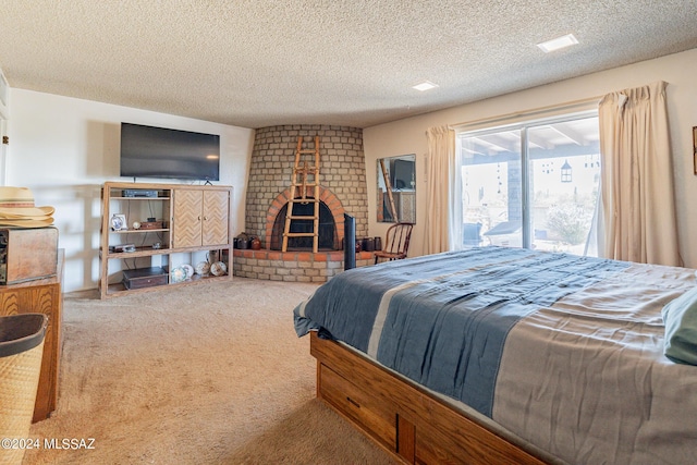 bedroom featuring carpet, a fireplace, a textured ceiling, and access to outside