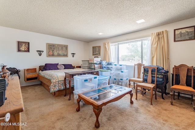 bedroom featuring light carpet and a textured ceiling