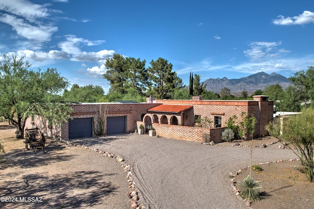 view of front of home with a mountain view and a garage