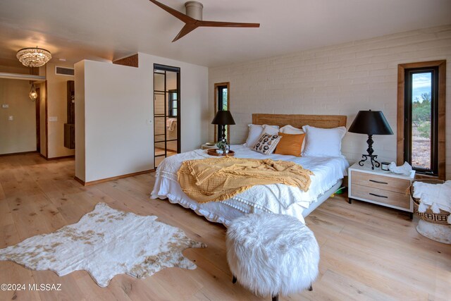 27 Circulo De Prado, Tubac, AZ 85646 - bedroom featuring ceiling fan, brick wall, and light wood-type flooring
