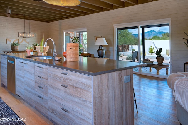 27 Circulo De Prado, Tubac, AZ 85646 - kitchen with wood-type flooring, sink, a center island with sink, and light brown cabinetry