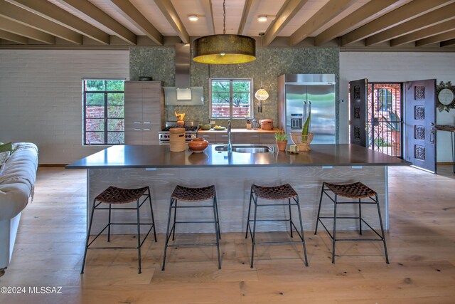 27 Circulo De Prado, Tubac, AZ 85646 - kitchen featuring stainless steel built in refrigerator, sink, plenty of natural light, light hardwood / wood-style floors, and wall chimney range hood