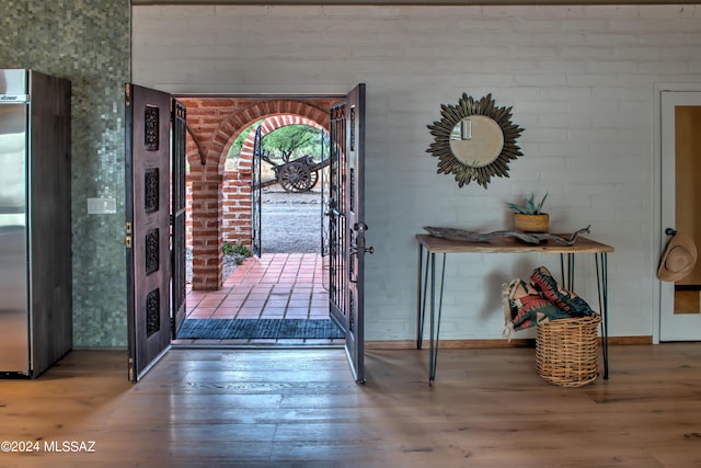 27 Circulo De Prado, Tubac, AZ 85646 - foyer featuring elevator, brick wall, and wood-type flooring