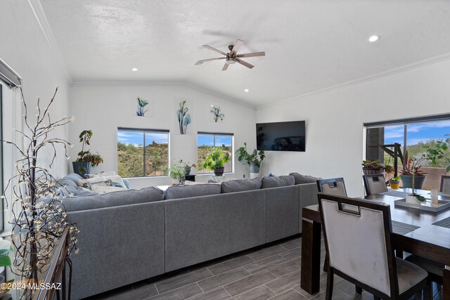 living room featuring dark hardwood / wood-style flooring, crown molding, ceiling fan, and lofted ceiling