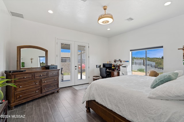 bedroom featuring dark hardwood / wood-style flooring, french doors, and access to exterior