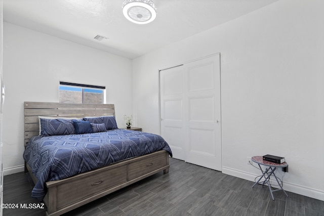 bedroom with dark wood-type flooring