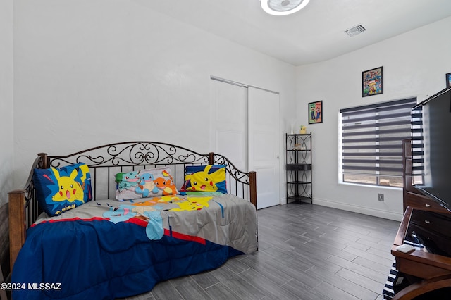 bedroom featuring wood-type flooring and a closet