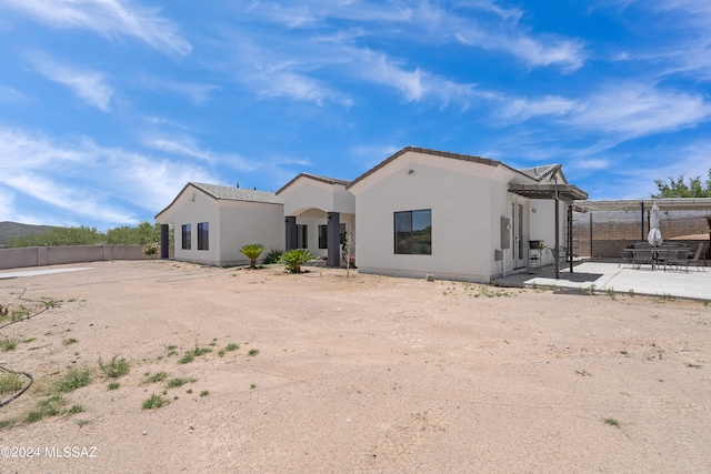 rear view of property featuring a patio area