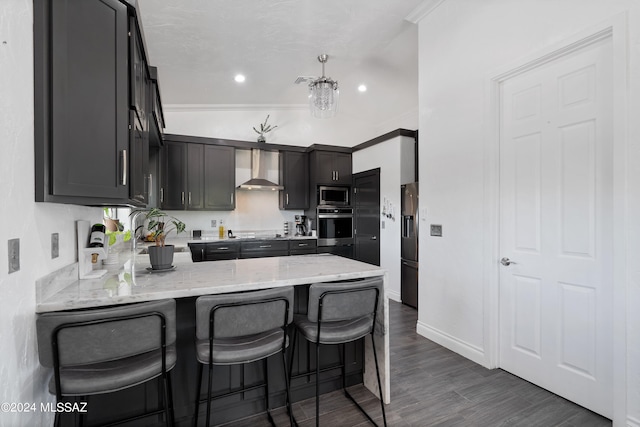 kitchen featuring stainless steel appliances, light stone counters, crown molding, dark hardwood / wood-style flooring, and wall chimney exhaust hood