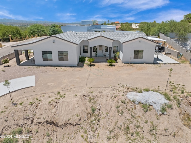 back of property with a patio