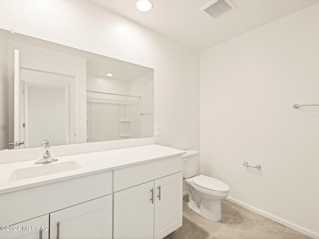 bathroom with toilet, a shower, and vanity