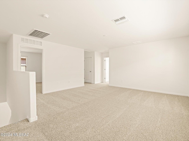 unfurnished room with light colored carpet