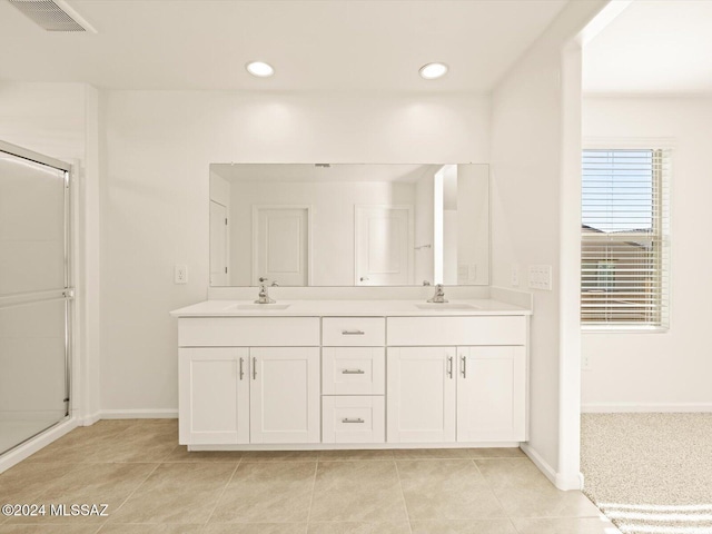 bathroom with vanity, tile patterned flooring, and a shower with shower door