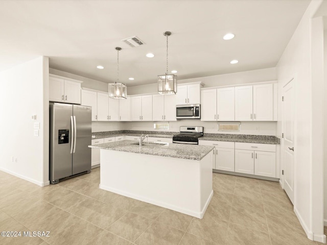 kitchen featuring stainless steel appliances, white cabinets, sink, and a kitchen island with sink