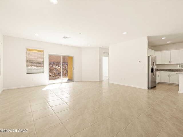 unfurnished living room with light tile patterned floors