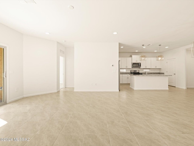 unfurnished living room featuring light tile patterned floors